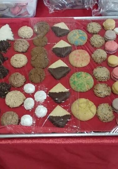 A tray of cookies on top of a red cloth.